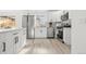 Bright kitchen with stainless steel appliances, white cabinetry, and modern backsplash at 3311 Jasmine St, Denver, CO 80207