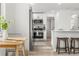 Modern kitchen features white cabinets, stainless steel appliances, and a breakfast bar at 3311 Jasmine St, Denver, CO 80207