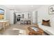 Open-concept living space with a breakfast bar, modern kitchen, and comfortable living area at 3311 Jasmine St, Denver, CO 80207