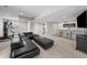Finished basement featuring a modern bar, fireplace, and comfortable seating area with a large sectional sofa at 10468 Ladera Dr, Lone Tree, CO 80124