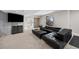 Relaxing basement living space with a large sectional sofa, modern console, and stylish barn door at 10468 Ladera Dr, Lone Tree, CO 80124