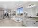 Luxurious bathroom featuring a soaking tub, walk-in shower, dual sinks, and a large window at 10468 Ladera Dr, Lone Tree, CO 80124