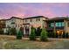 Rear view of a modern home with multiple decks, lush landscaping, and a serene backyard at 10468 Ladera Dr, Lone Tree, CO 80124
