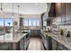 Spacious kitchen featuring custom cabinets, high-end appliances, granite counters and large island seating at 10468 Ladera Dr, Lone Tree, CO 80124