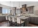 Gourmet kitchen boasts granite countertops, a large island, stainless steel appliances, and modern pendant lighting at 10468 Ladera Dr, Lone Tree, CO 80124
