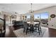 Open-concept living room with fireplace, hardwood floors, natural light and sliding doors to the deck at 10468 Ladera Dr, Lone Tree, CO 80124