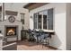 Outdoor bar area with a built-in fireplace, bar seating, and a pass-through window at 10468 Ladera Dr, Lone Tree, CO 80124