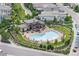 Aerial view of a community pool with ample seating, lush landscaping, and a pergola at 10468 Ladera Dr, Lone Tree, CO 80124