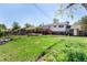Spacious backyard with a wooden deck, raised garden beds, and lush green grass at 1081 E 119Th Pl, Northglenn, CO 80233