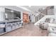 Finished basement featuring wood-look floors and a large television at 1081 E 119Th Pl, Northglenn, CO 80233