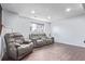 Finished basement area featuring tile floors, neutral walls, and comfortable seating at 1081 E 119Th Pl, Northglenn, CO 80233