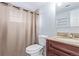 Bathroom featuring vanity with wood cabinets, toilet, and shower with curtain at 1081 E 119Th Pl, Northglenn, CO 80233