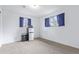 Bedroom with carpeted floors and two windows with blue curtains at 1081 E 119Th Pl, Northglenn, CO 80233