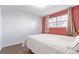 Cozy bedroom featuring hardwood floors, bright windows, and a comfortable bed at 1081 E 119Th Pl, Northglenn, CO 80233