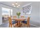 Cozy dining room with hardwood table, four chairs, and natural light at 1081 E 119Th Pl, Northglenn, CO 80233
