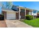 Charming two-story home with a brick facade, attached garage, and inviting front porch at 1081 E 119Th Pl, Northglenn, CO 80233