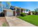 Charming brick home boasts a well-manicured lawn, attached garage, and welcoming front porch at 1081 E 119Th Pl, Northglenn, CO 80233