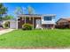 Charming two-story home with a brick facade, manicured lawn, and inviting front porch at 1081 E 119Th Pl, Northglenn, CO 80233