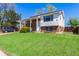 Charming two-story home with a brick facade, manicured lawn, and inviting front porch at 1081 E 119Th Pl, Northglenn, CO 80233