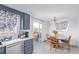 Modern kitchen featuring gray cabinets, stainless appliances, and dining room view at 1081 E 119Th Pl, Northglenn, CO 80233