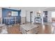 Bright living room with hardwood floors, an accent wall, and staircase access at 1081 E 119Th Pl, Northglenn, CO 80233