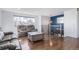 Bright living room with hardwood floors, large windows, and staircase access at 1081 E 119Th Pl, Northglenn, CO 80233