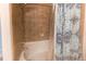 Tiled bathtub and shower combo with a decorative shower curtain at 546 Lost Valley Pt, Castle Rock, CO 80108