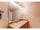 Bathroom featuring a double sink vanity with a large mirror and modern lighting at 546 Lost Valley Pt, Castle Rock, CO 80108