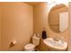 Cozy half-bathroom featuring a pedestal sink and soft neutral color palette at 546 Lost Valley Pt, Castle Rock, CO 80108