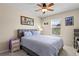 Bright bedroom with a large window, ceiling fan, and comfortable-looking bed at 546 Lost Valley Pt, Castle Rock, CO 80108