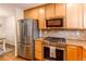 Modern kitchen with stainless steel appliances, granite countertops, and hardwood floors at 546 Lost Valley Pt, Castle Rock, CO 80108