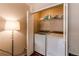 Laundry room with side-by-side washer and dryer, shelving, and a modern lamp at 546 Lost Valley Pt, Castle Rock, CO 80108