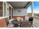 Covered back porch with outdoor dining furniture and a view of neighborhood at 12575 Sandstone Dr, Broomfield, CO 80021