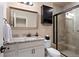 Tiled bathroom featuring a glass-enclosed shower, granite countertop vanity, and modern fixtures at 12575 Sandstone Dr, Broomfield, CO 80021