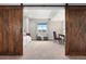Bedroom view with barn doors showing desk, chair, window and bed at 12575 Sandstone Dr, Broomfield, CO 80021