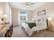 Bright bedroom featuring a ceiling fan, plush carpet, and a decorative throw blanket at 12575 Sandstone Dr, Broomfield, CO 80021