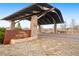 Stone Skystone entrance featuring signage, landscaping, and a paved road at 12575 Sandstone Dr, Broomfield, CO 80021