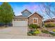 Charming two-story home featuring stone accents, a two-car garage, and a well-maintained front yard with landscaping at 12575 Sandstone Dr, Broomfield, CO 80021