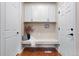 Well-organized hallway with bench seating, storage cabinets, and access to multiple rooms at 12575 Sandstone Dr, Broomfield, CO 80021