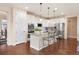 Bright kitchen features white cabinets, stainless steel appliances, granite countertops, and an eat-in island at 12575 Sandstone Dr, Broomfield, CO 80021