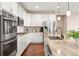 Bright kitchen features white cabinets, stainless steel appliances, granite countertops, and a stainless sink at 12575 Sandstone Dr, Broomfield, CO 80021