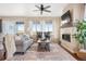 Inviting living room with large windows, a fireplace, and neutral decor for a cozy atmosphere at 12575 Sandstone Dr, Broomfield, CO 80021