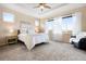 Serene main bedroom with plush carpeting, tray ceiling, ample natural light, and tranquil views at 12575 Sandstone Dr, Broomfield, CO 80021