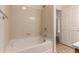 Bright bathroom with tiled walls and floors features a large tub and shower combo at 9633 E 5Th Ave # 10304, Denver, CO 80230