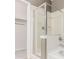 This bright bathroom features a glass enclosed shower, neutral colors, and sleek fixtures at 9633 E 5Th Ave # 10304, Denver, CO 80230