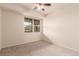 Bright bedroom with neutral walls, plush carpet, and a large window providing natural light and neighborhood views at 9633 E 5Th Ave # 10304, Denver, CO 80230