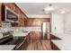 Modern kitchen with stainless steel appliances, dark cabinets, and white countertop at 9633 E 5Th Ave # 10304, Denver, CO 80230
