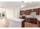 Bright kitchen featuring stainless steel appliances, dark cabinets, and a large island at 9633 E 5Th Ave # 10304, Denver, CO 80230