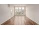 Empty living room with hardwood floors, light walls, and lots of natural light from the big windows at 9633 E 5Th Ave # 10304, Denver, CO 80230