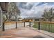 View of a nice backyard deck with a black metal and wood railing on a partly cloudy day at 6000 Yarrow St, Arvada, CO 80004